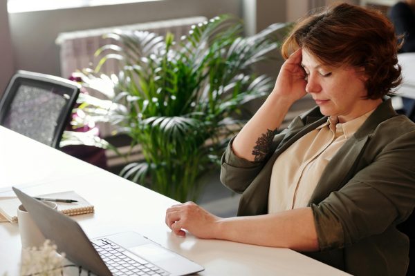 woman in office feeling unwell